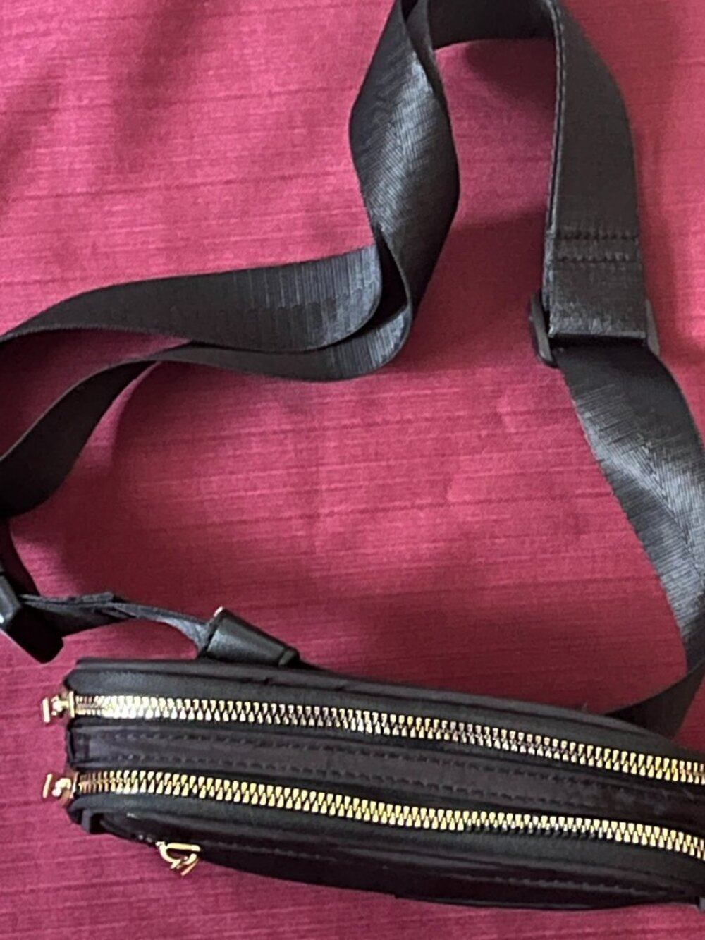 Black nylon belt crossbody bag for phone card and keys.